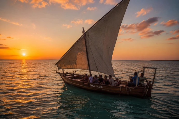 Traditional dhow sailing at sunset in Zanzibar